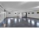 Spacious garage with epoxy flooring, white walls, recessed lighting, and garage door at 10354 E Celestial Dr, Scottsdale, AZ 85262
