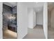 Hallway leading to bathroom with modern marble wall and floating vanity at 10354 E Celestial Dr, Scottsdale, AZ 85262