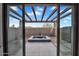 This outdoor hot tub is surrounded by a pergola and desert landscaping at 10354 E Celestial Dr, Scottsdale, AZ 85262