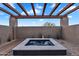 Outdoor hot tub with wood pergola and desert landscaping at 10354 E Celestial Dr, Scottsdale, AZ 85262