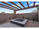 Outdoor hot tub with wood pergola and desert landscaping at 10354 E Celestial Dr, Scottsdale, AZ 85262