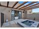Outdoor hot tub with wood pergola with a view into the bathroom at 10354 E Celestial Dr, Scottsdale, AZ 85262