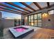 A luxurious hot tub with wood beams and a tiled patio offers a relaxing outdoor experience at 10354 E Celestial Dr, Scottsdale, AZ 85262
