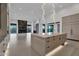 Bright kitchen with modern island, lighting, and marble accent wall providing a sleek, luxurious design at 10354 E Celestial Dr, Scottsdale, AZ 85262