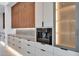 Kitchen features sleek built-in espresso machine and modern lighting, blending style and functionality at 10354 E Celestial Dr, Scottsdale, AZ 85262