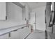 Bright laundry room features sleek white cabinets, gray countertop, and modern gray tiled floors at 10354 E Celestial Dr, Scottsdale, AZ 85262