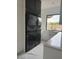 Stylish laundry room with modern appliances, sleek cabinetry, and natural light from the window at 10354 E Celestial Dr, Scottsdale, AZ 85262