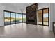 Open living room features large windows with a pool view and a modern fireplace at 10354 E Celestial Dr, Scottsdale, AZ 85262