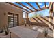 Covered patio area with stucco walls and desert landscaping at 10354 E Celestial Dr, Scottsdale, AZ 85262