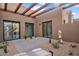 Covered patio with desert landscaping and multiple sliding glass doors at 10354 E Celestial Dr, Scottsdale, AZ 85262
