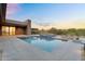Backyard oasis with a modern pool, water feature, and stunning desert views at 10354 E Celestial Dr, Scottsdale, AZ 85262