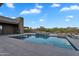Outdoor kitchen and pool featuring a spa and desert surroundings at 10354 E Celestial Dr, Scottsdale, AZ 85262