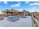 Exterior view of luxury home showcasing the pool, fire pit, and desert landscaping at 10354 E Celestial Dr, Scottsdale, AZ 85262