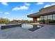Backyard view of sparkling swimming pool, modern spa, and desert landscape at 10354 E Celestial Dr, Scottsdale, AZ 85262