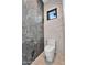 Modern toilet room features designer toilet, and unique marble accent wall at 10354 E Celestial Dr, Scottsdale, AZ 85262