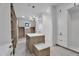 Bright walk-in closet features open shelving, ample storage, and a stunning chandelier at 10354 E Celestial Dr, Scottsdale, AZ 85262