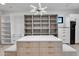 Modern walk-in closet boasts a unique island, ample shelving, and an open design at 10354 E Celestial Dr, Scottsdale, AZ 85262