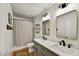 Bright bathroom featuring double sinks, framed mirrors and shower with gray patterned curtain at 10778 W Via Del Sol --, Peoria, AZ 85373