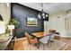 Modern dining room featuring a stylish chandelier, a decorative accent wall, and seating for four at 10778 W Via Del Sol --, Peoria, AZ 85373