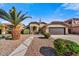 Charming single-story home with a desert landscape, mature palm trees, and a two-car garage at 10778 W Via Del Sol --, Peoria, AZ 85373