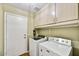 Functional laundry room with washer, dryer, cabinets, and a utility sink at 10778 W Via Del Sol --, Peoria, AZ 85373