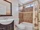 Bathroom with tiled shower-over-tub combo, dark wood vanity, and decorative shower curtain at 108 W Ivyglen St, Mesa, AZ 85201