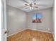 Vacant bedroom featuring hardwood flooring, neutral paint, a ceiling fan, and a window view at 108 W Ivyglen St, Mesa, AZ 85201