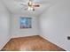 Vacant bedroom featuring hardwood flooring, neutral paint, a ceiling fan, and a window view at 108 W Ivyglen St, Mesa, AZ 85201