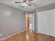 Vacant bedroom featuring hardwood flooring, neutral paint, a ceiling fan, and closet at 108 W Ivyglen St, Mesa, AZ 85201