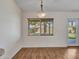 Dining area with wood-look floors, a modern light fixture, and a view of the backyard at 108 W Ivyglen St, Mesa, AZ 85201