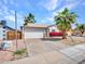 Charming home with well-manicured front yard, lush landscaping, and a two-car garage at 108 W Ivyglen St, Mesa, AZ 85201