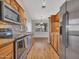 Spacious kitchen with wood floors, stainless steel appliances, and wood cabinetry at 108 W Ivyglen St, Mesa, AZ 85201