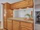 Charming kitchen features wood cabinets, stainless steel refrigerator, and granite countertops at 108 W Ivyglen St, Mesa, AZ 85201
