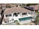 A beautiful aerial view shows a home with a private pool and outdoor seating area at 11267 E Beck Ln, Scottsdale, AZ 85255