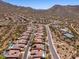 Sweeping aerial view showcasing the desert landscape and community amenities, including a pool and tennis courts at 11267 E Beck Ln, Scottsdale, AZ 85255