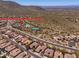 Aerial view of a community with a community center that includes a pool and tennis courts with mountain views at 11267 E Beck Ln, Scottsdale, AZ 85255