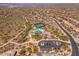 Expansive aerial view of the community showcasing lush landscaping, pool, tennis courts, and desert surroundings at 11267 E Beck Ln, Scottsdale, AZ 85255