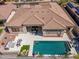 Luxury home's aerial view showcases a swimming pool, outdoor dining, and seating areas, perfect for entertaining guests at 11267 E Beck Ln, Scottsdale, AZ 85255
