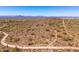 An aerial view displays walking paths in the beautiful desert landscape and mountains at 11267 E Beck Ln, Scottsdale, AZ 85255