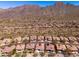 Scenic aerial shot of a desert community nestled against mountains, highlighting the neighborhood's layout at 11267 E Beck Ln, Scottsdale, AZ 85255