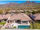 Expansive backyard with a pool, patio, and mountain views, ideal for relaxing and outdoor enjoyment at 11267 E Beck Ln, Scottsdale, AZ 85255