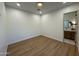 Neutral bedroom with wood floors, a view into the bathroom, and ample space at 11267 E Beck Ln, Scottsdale, AZ 85255