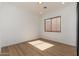 Neutral toned bedroom with a window and light wood floors at 11267 E Beck Ln, Scottsdale, AZ 85255
