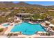 A refreshing community pool, framed by desert landscaping and distant mountain views, offers a perfect escape at 11267 E Beck Ln, Scottsdale, AZ 85255