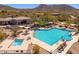 Inviting community pool area featuring ample seating, shade, and a jacuzzi, perfect for relaxation and recreation at 11267 E Beck Ln, Scottsdale, AZ 85255