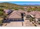 Inviting home featuring a three-car garage, desert landscaping, and mountain views for a serene outdoor experience at 11267 E Beck Ln, Scottsdale, AZ 85255