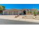 Beautiful home with desert landscaping and a three-car garage, offering curb appeal and functionality at 11267 E Beck Ln, Scottsdale, AZ 85255