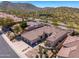 Beautiful home with a three-car garage, desert landscaping, and mountain views creating a serene outdoor experience at 11267 E Beck Ln, Scottsdale, AZ 85255
