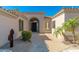 Charming home entrance with desert landscaping and a dark wooden door, welcoming visitors with Southwestern charm at 11267 E Beck Ln, Scottsdale, AZ 85255