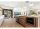 Modern kitchen featuring a large island, stainless steel appliances, and seamless flow to the outdoors at 11267 E Beck Ln, Scottsdale, AZ 85255